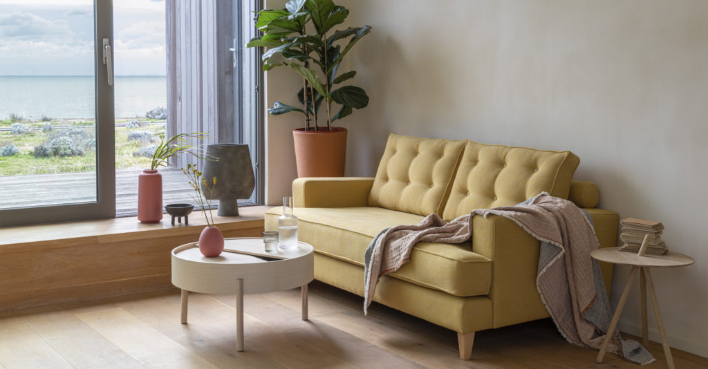 The bright yellow Mistral Sofa in a modern living room