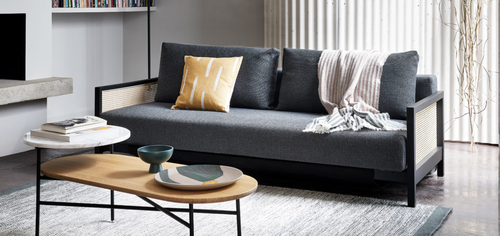 Cane Sofa with grey upholstery in a living room